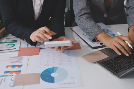 Accounting company provide finance and taxation planning for profitable cash flow, Auditor and accountant team working in office, analyze financial data and accounting record with calculator.Insightの写真素材