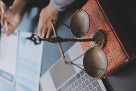 Judge gavel with Justice lawyers having team meeting at law firm background. Concepts of Law and Legal services.の写真素材