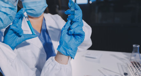 Researcher using a professional microscope