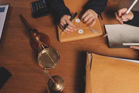 Attractive young lawyer in office Business woman and lawyers discussing contract papers with brass...