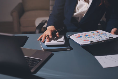 Expert woman asian female people review data number costing managerial account prepare monthly actual cost variance report at tax audit office. ESG sheet budget control ERP process service project.の写真素材