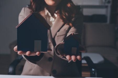 Female Real Estate Broker presenting and advised to 
model home and building project detail in the office, sign purchase sales contract, agreements concerned mortgage loan offer and insurance.の写真素材