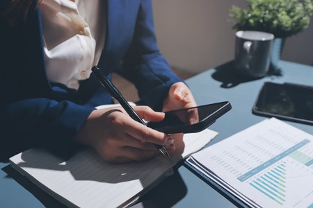 Expert woman asian female people review data number costing managerial account prepare monthly actual cost variance report at tax audit office. ESG sheet budget control ERP process service project.の写真素材