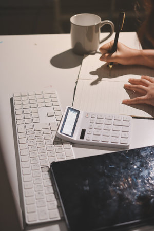 Expert woman asian female people review data number costing managerial account prepare monthly actual cost variance report at tax audit office. ESG sheet budget control ERP process service project.の写真素材