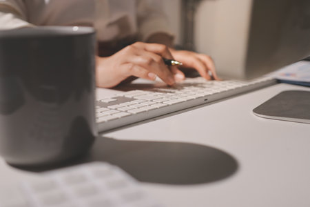 Expert woman asian female people review data number costing managerial account prepare monthly actual cost variance report at tax audit office. ESG sheet budget control ERP process service project.の写真素材