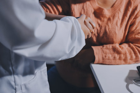 Orthopedist examining patient in hospitalの写真素材