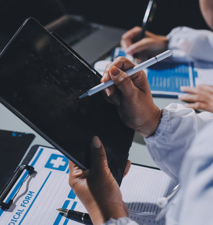 Male and female doctors are having a meeting in a hospital room.の写真素材