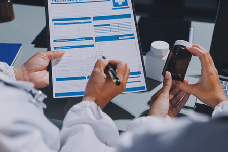 Male and female doctors are having a meeting in a hospital room.の写真素材