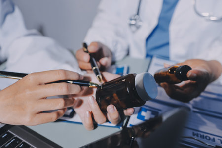 Male and female doctors are having a meeting in a hospital room.の写真素材