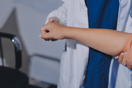 Orthopedist examining patient in hospitalの写真素材