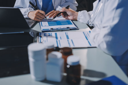 Male and female doctors are having a meeting in a hospital room.の写真素材