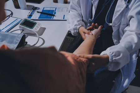 Orthopedist examining patient in hospital