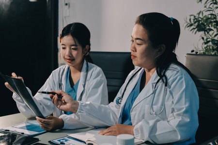 Male and female doctors are having a meeting in a hospital room.の写真素材