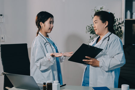 Male and female doctors are having a meeting in a hospital room.の写真素材