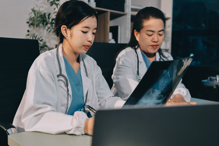 Male and female doctors are having a meeting in a hospital room.の写真素材