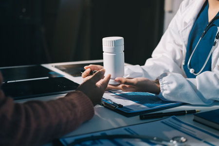 Specialized doctor is explaining taking medicine to a patient. Health and medicine consultation.の写真素材