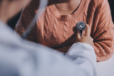 The doctor examines the patient's heart to analyze and listen to whether the heart rhythm is abnormal or normal in order to diagnose and draw conclusions from the patient for further treatment.の写真素材