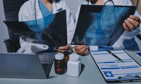 Male and female doctors are having a meeting in a hospital room.
