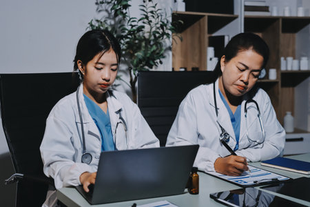 Male and female doctors are having a meeting in a hospital room.の写真素材