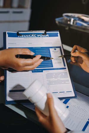 Male and female doctors are having a meeting in a hospital room.の写真素材