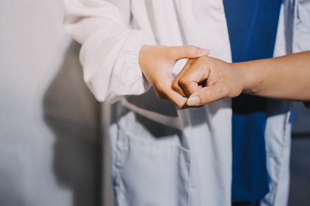 Orthopedist examining patient in hospitalの写真素材