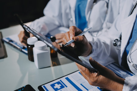 Male and female doctors are having a meeting in a hospital room.