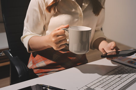 Expert woman asian female people review data number costing managerial account prepare monthly actual cost variance report at tax audit office. ESG sheet budget control ERP process service project.の写真素材