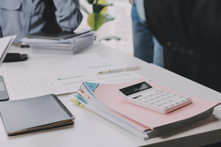 Team of financial advisory services. Advisor showing plan of investment to clients in the consultancy office.の写真素材