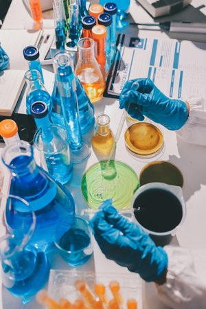 Scientist pipetting medical samples into microplate in laboratory