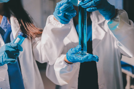 Scientist pipetting medical samples into microplate in laboratoryの写真素材