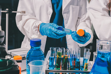 Scientist pipetting medical samples into microplate in laboratory