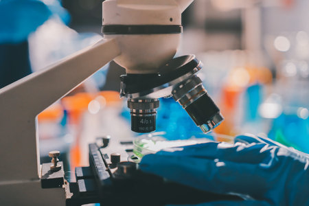 Scientist pipetting medical samples into microplate in laboratoryの写真素材