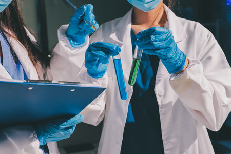 Scientist pipetting medical samples into microplate in laboratoryの写真素材