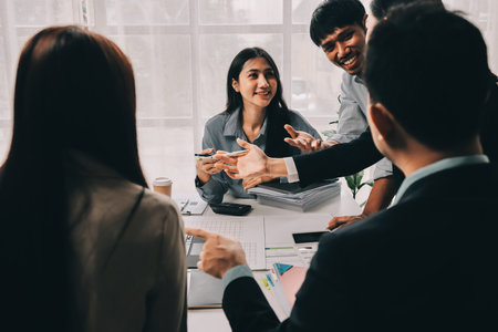 Team of financial advisory services. Asian advisor showing plan of investment to clients in the consultancy office.の写真素材