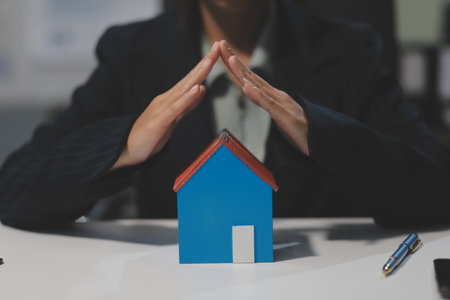 Real estate agents explain models of housing estates in projects to elaborate to clients, explaining and presenting information about homes and purchasing loans. Real estate trading concept.の写真素材