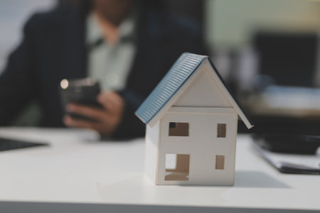 Real estate agents explain models of housing estates in projects to elaborate to clients, explaining and presenting information about homes and purchasing loans. Real estate trading concept.の写真素材
