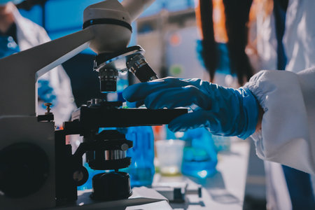 Scientist pipetting medical samples into microplate in laboratory