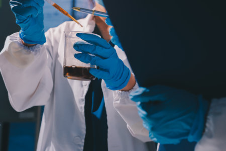 Scientist pipetting medical samples into microplate in laboratoryの写真素材