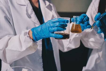 Scientist pipetting medical samples into microplate in laboratoryの写真素材