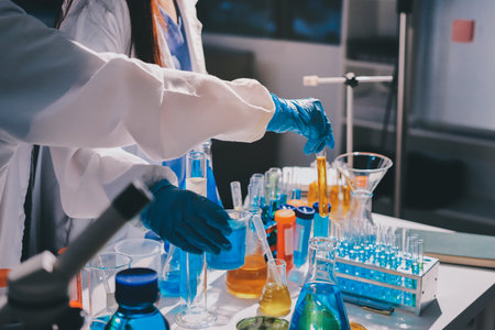 Scientist pipetting medical samples into microplate in laboratory