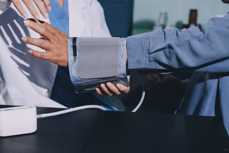 Close-up of doctor checking blood pressure