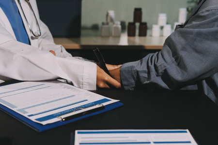Doctor, patient and hands on wrist with pulse for blood pressure, wellness or consulting in hospital. Female medical professional, black woman or helping hand for healthcare, advice or test in clinicの写真素材