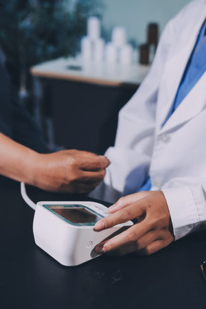 Close-up of doctor checking blood pressureの写真素材
