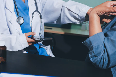 Doctor, patient and hands on wrist with pulse for blood pressure, wellness or consulting in hospital. Female medical professional, black woman or helping hand for healthcare, advice or test in clinicの写真素材