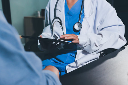 Doctor, patient and hands on wrist with pulse for blood pressure, wellness or consulting in hospital. Female medical professional, black woman or helping hand for healthcare, advice or test in clinicの写真素材