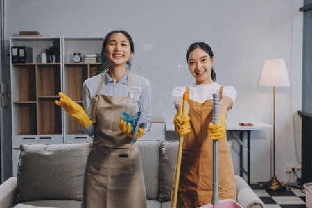 Female janitor with vacuum cleaner in roomの写真素材