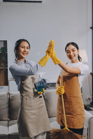 Female janitor with vacuum cleaner in roomの写真素材