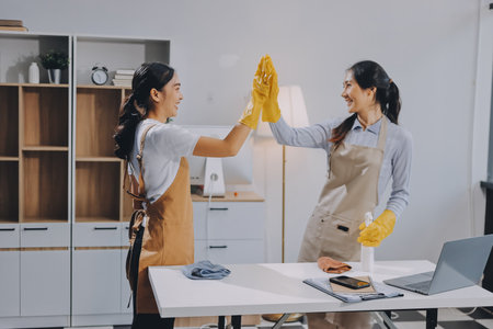 Female janitor with vacuum cleaner in roomの写真素材