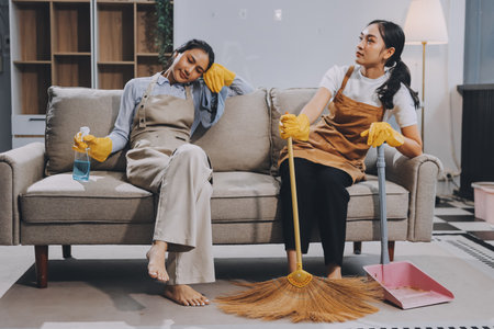 Female janitor with vacuum cleaner in roomの写真素材