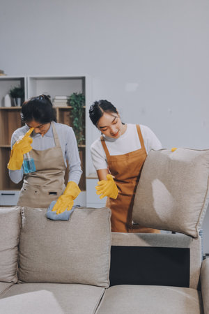 Female janitor with vacuum cleaner in roomの写真素材